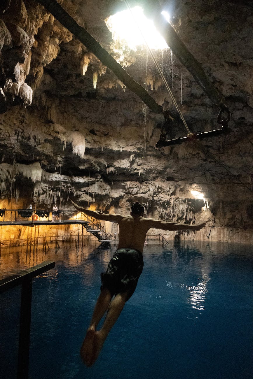 a man diving on a underground lagoon